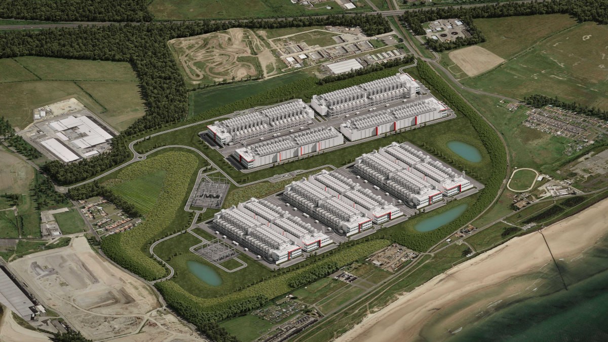 Aerial view of a data centre complex beside a beach, with electrical substations and transformers between the buildings